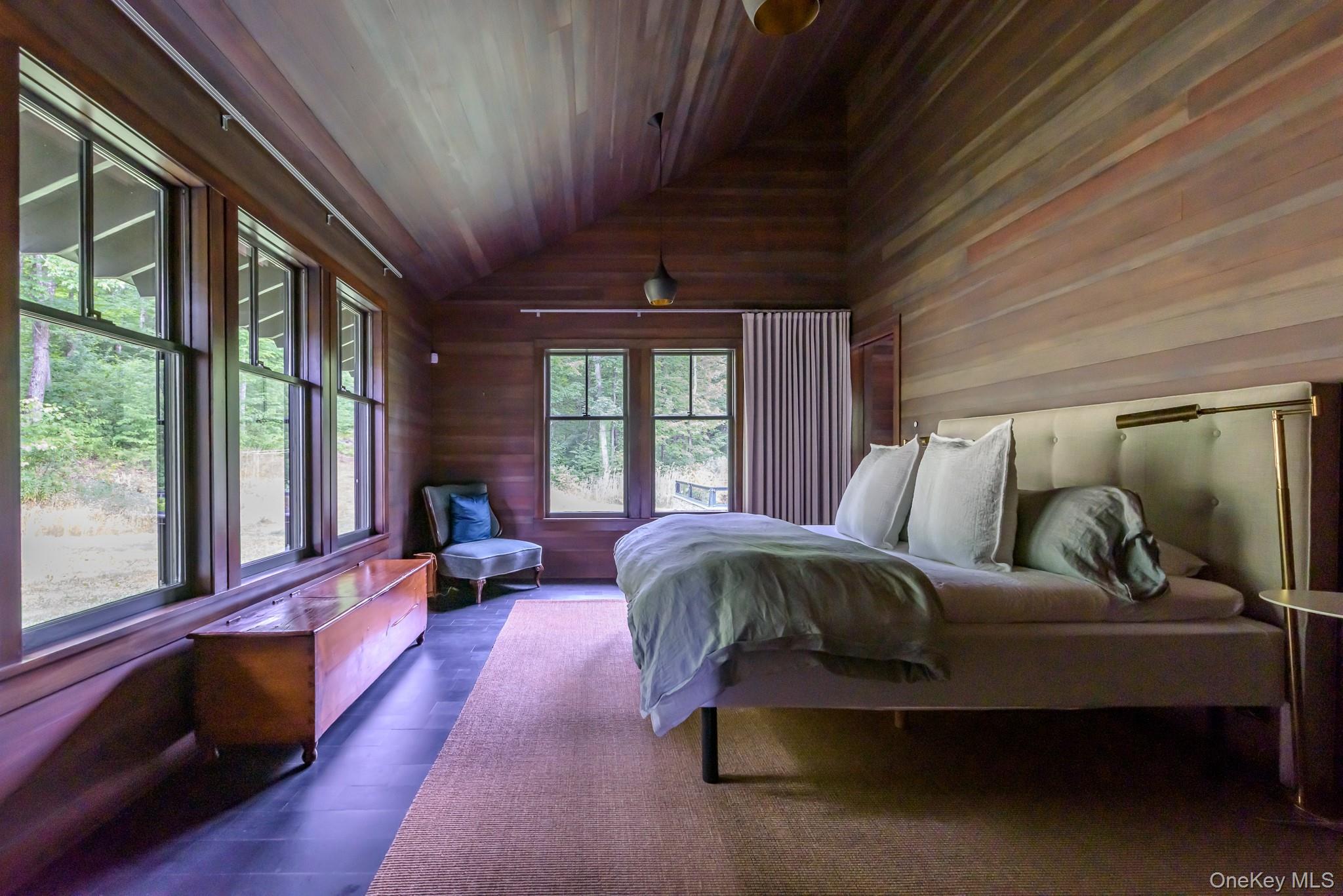 890 Bald Mountain Road Austerlitz, NY 12017 - Photo 17 of 28 Bedroom featuring wood ceiling, vaulted ceiling, hardwood / wood-style flooring, and wood walls