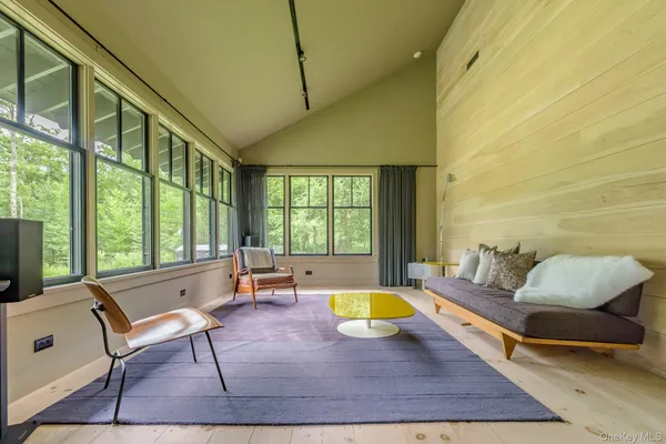 a living room with patio furniture and a large window