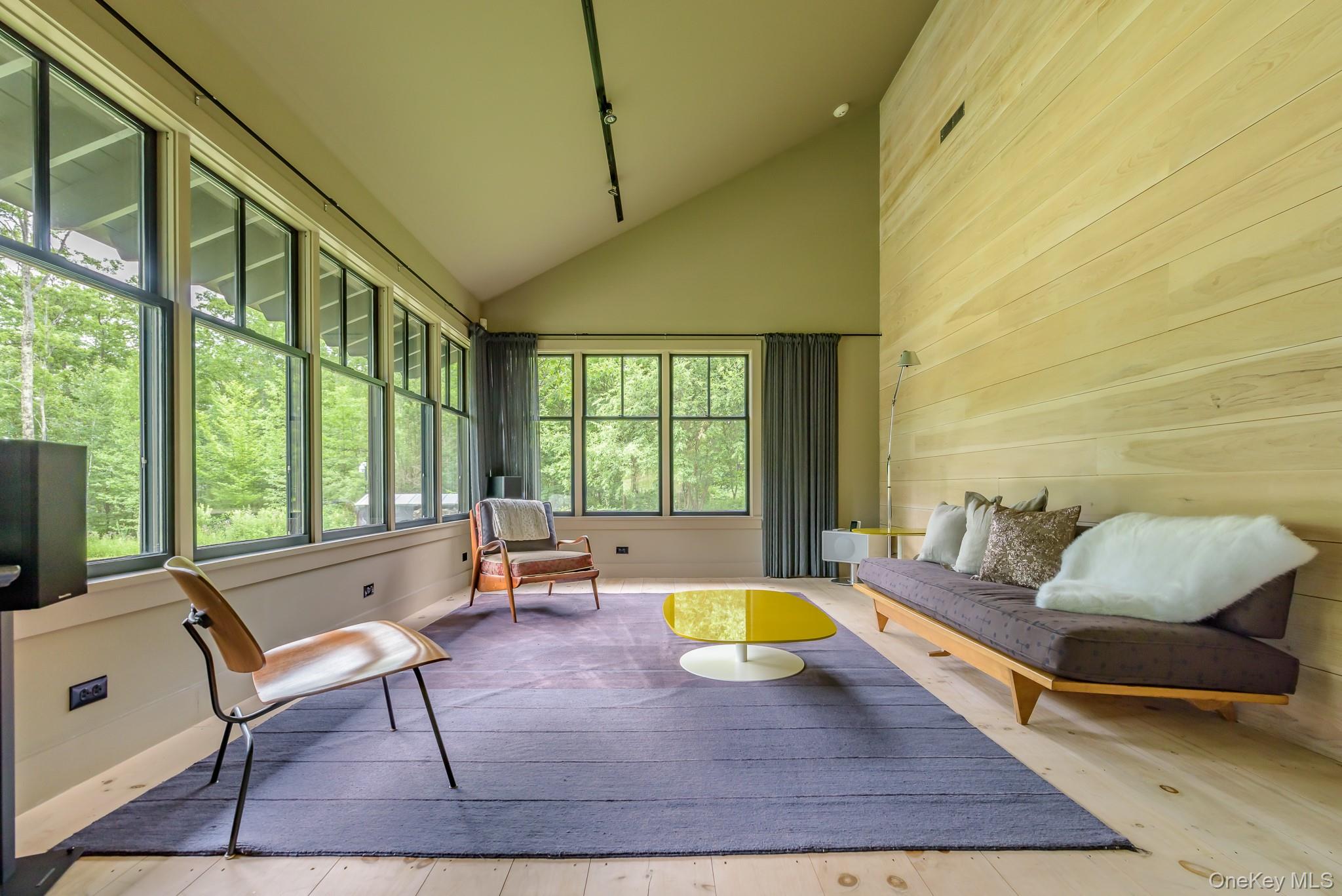 890 Bald Mountain Road Austerlitz, NY 12017 - Photo 21 of 28 Sunroom / solarium featuring wood walls, high vaulted ceiling, and wood-type flooring