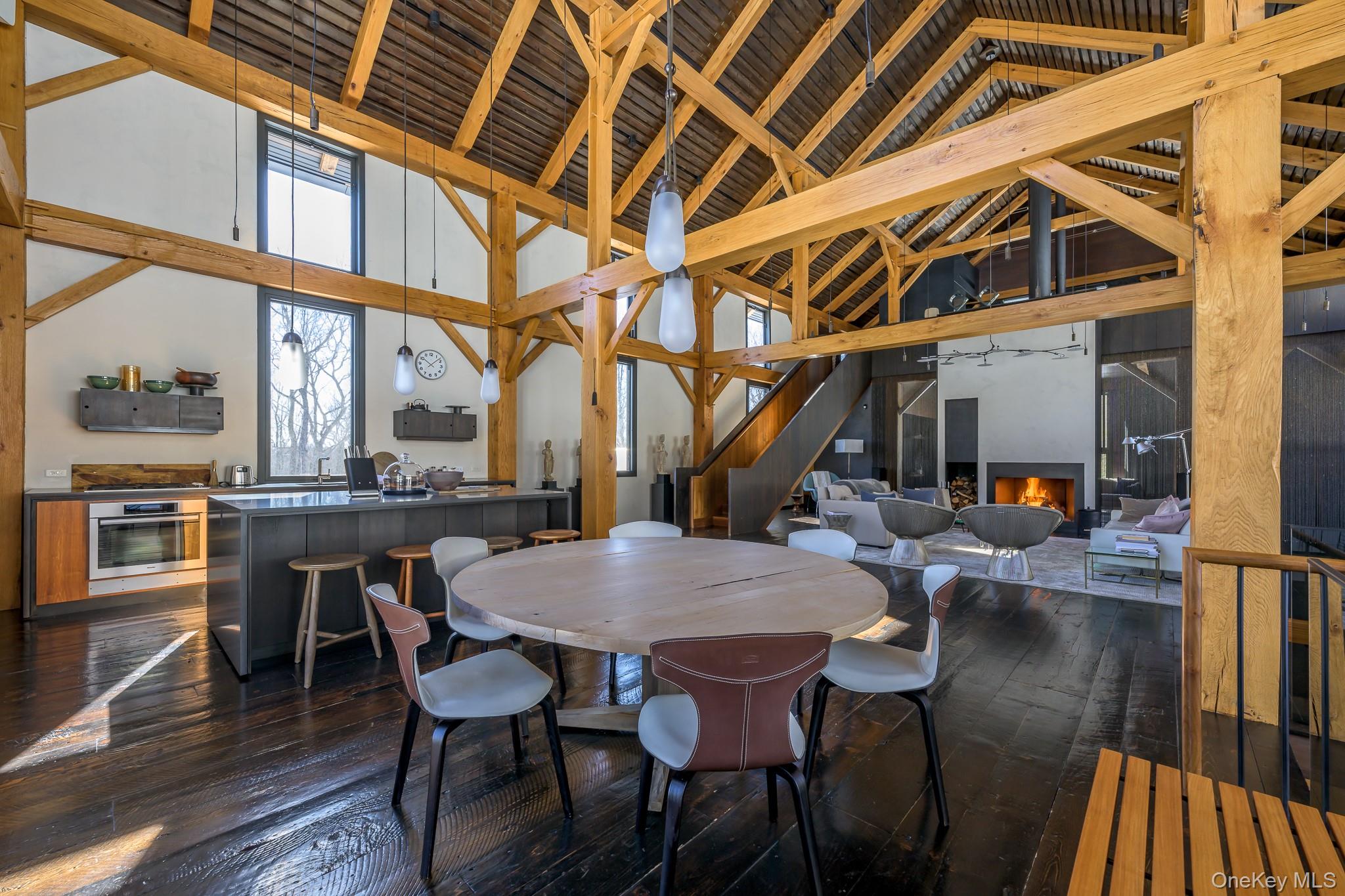 890 Bald Mountain Road Austerlitz, NY 12017 - Photo 10 of 28 Dining space with a warm lit fireplace, dark wood-type flooring, high vaulted ceiling, and beam ceiling