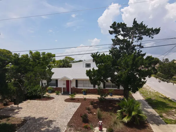 a aerial view of a house with a yard and garden