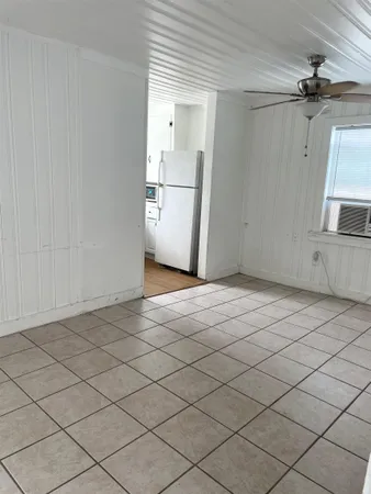 en empty room with a white cabinet and a sink