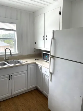 a kitchen with stainless steel appliances a refrigerator sink and cabinets