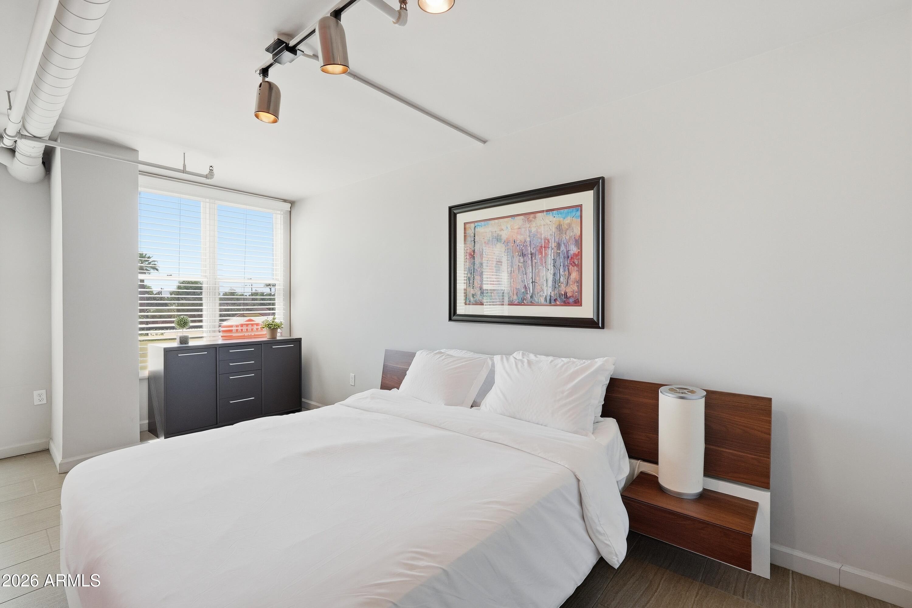 535 West Thomas Road, Unit 210 Phoenix, AZ 85013 - Photo 21 of 40 a bedroom with a large bed and a desk