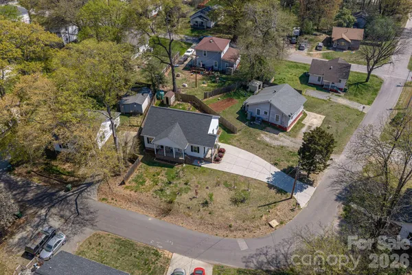 an aerial view of a house with a yard basket ball court and outdoor seating