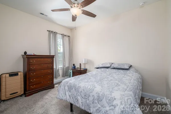 a bedroom with a bed and a ceiling fan