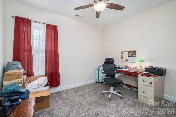a living room with furniture and a chair
