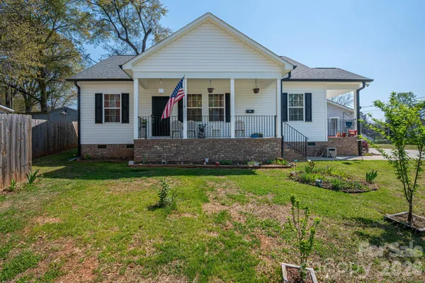 a front view of a house with a yard and porch