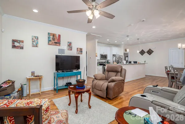 a living room with furniture and a chandelier