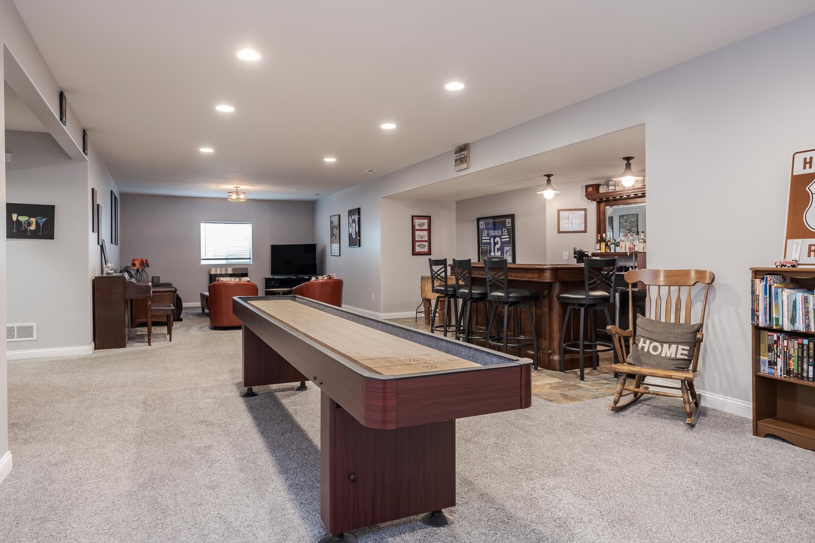 2603 Piney Run Bloomington, IL 61705 - Photo 29 of 42 a large living room with kitchen island granite countertop a table chairs and a refrigerator