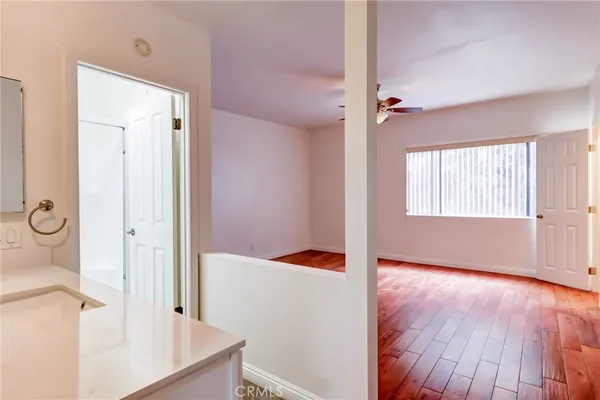 a view of a room with wooden floor and cabinet