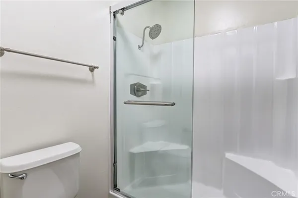 a bathroom with a shower and toilet