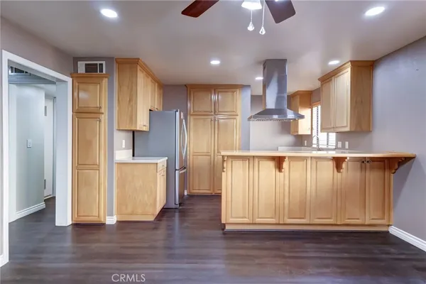 a view of kitchen with stainless steel appliances granite countertop refrigerator oven stove and a sink with wooden floor