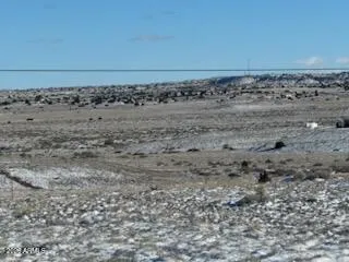 a view of car parked on road with ocean view