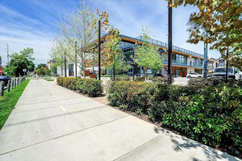 a view of a garden with a building in the background