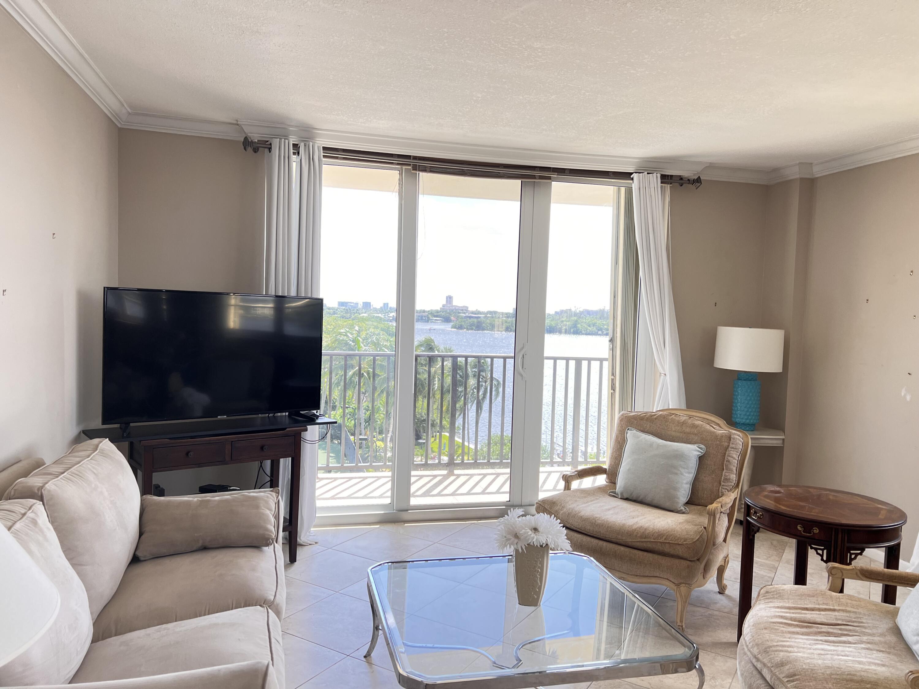 2121 North Ocean Boulevard, Unit 609W Boca Raton, FL 33431 - Photo 11 of 27 a living room with furniture and a flat screen tv