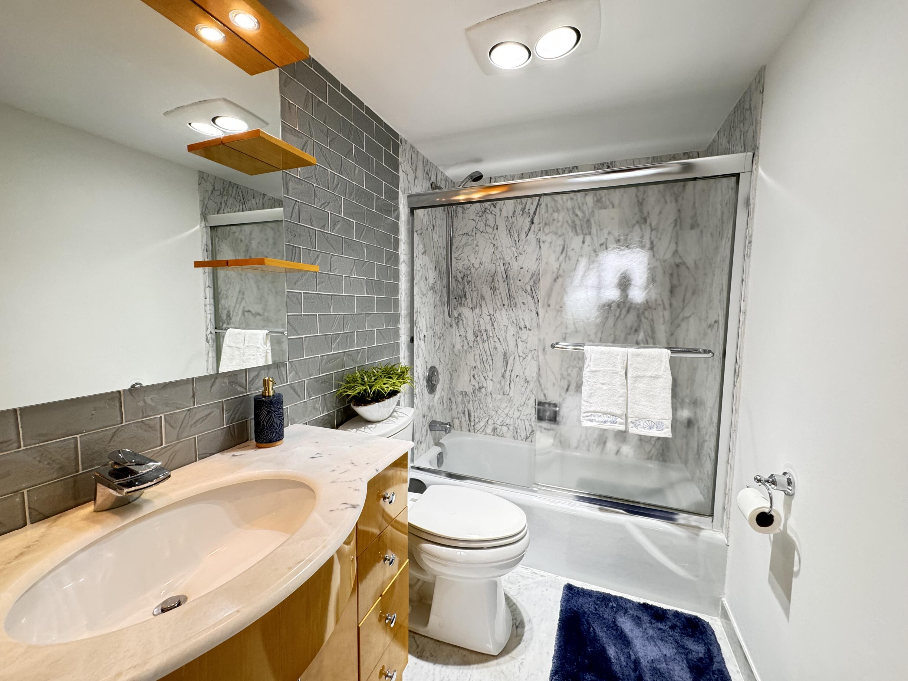 2121 North Ocean Boulevard, Unit 609W Boca Raton, FL 33431 - Photo 12 of 27 a bathroom with a sink toilet and shower