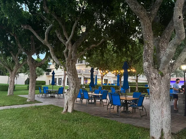 a roof deck with table and chairs a barbeque