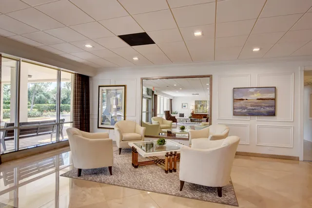 a living room with furniture and a view of dining room