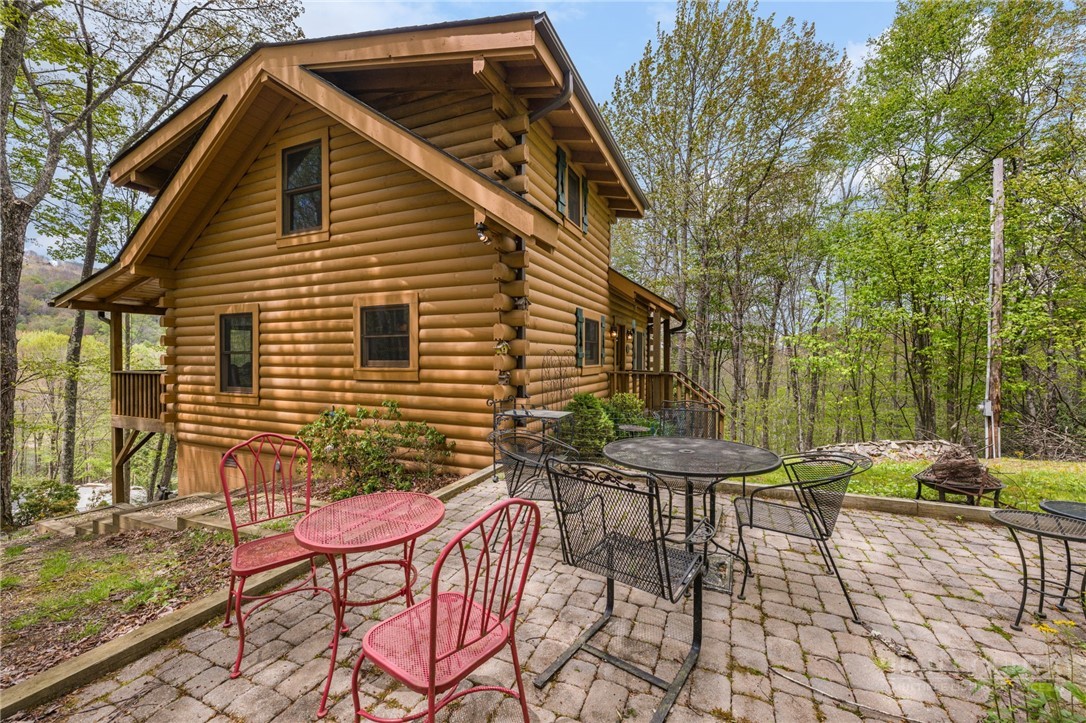 259 Greenbriar Road Beech Mountain, NC 28604 - Photo 32 of 41 a patio with table and chairs and potted plants
