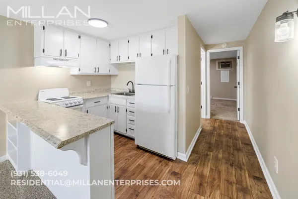 a kitchen with stainless steel appliances granite countertop a refrigerator and a stove