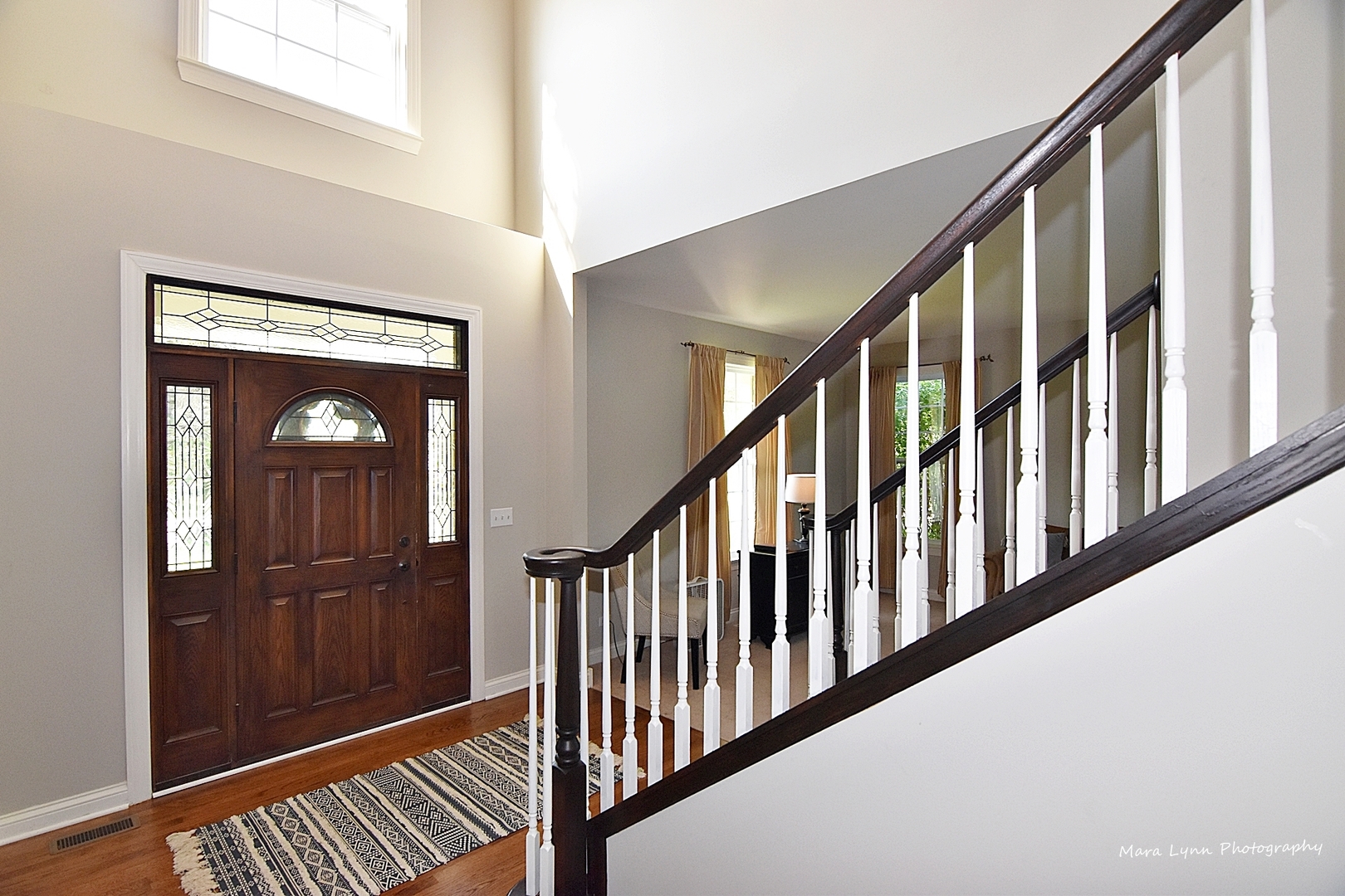 37W200 Red Gate Road St. Charles, IL 60175 - Photo 3 of 47 a view of a hallway with wooden floor and staircase