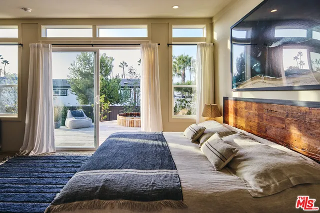 a living room with a bed furniture and next to a window