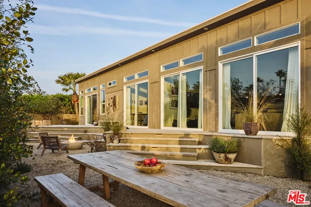 front view of a house with a lounge chair