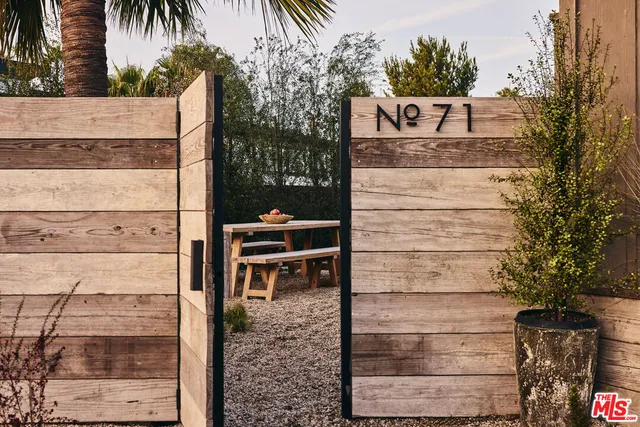 a view of a wooden door and potted plants