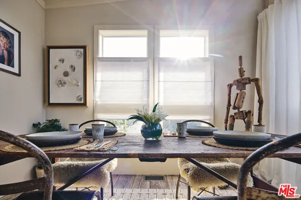 a table with a vase and flowers on it