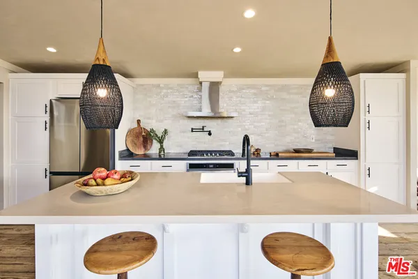 a kitchen with a dining table and chairs