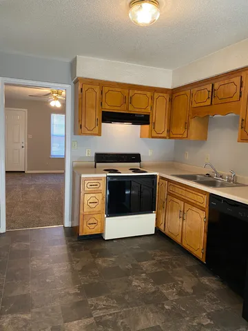 a kitchen with stainless steel appliances a stove a sink and a microwave