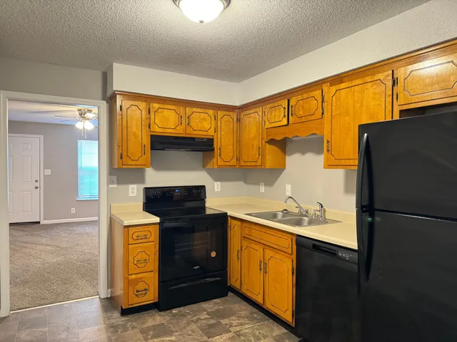 a kitchen with a refrigerator and a stove
