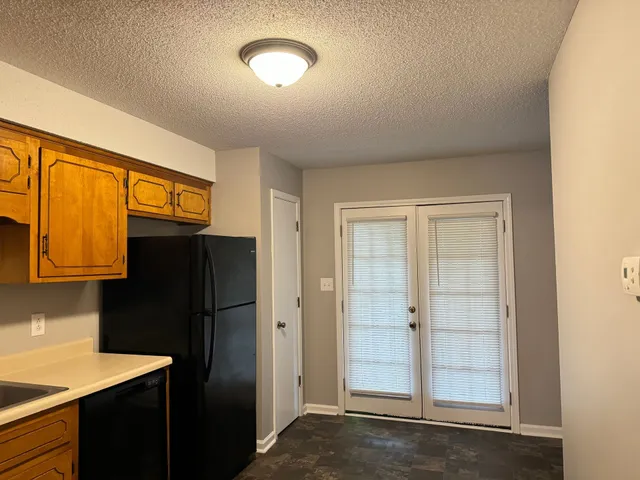 a kitchen with stainless steel appliances granite countertop a refrigerator and a sink
