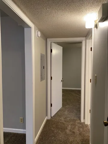view of a hallway with wooden floor