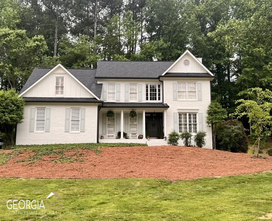 2390 Briar Ridge Way Cumming, GA 30041 - Photo 1 of 1 a front view of a house with a yard
