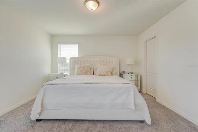 a room with a bed and a night stand