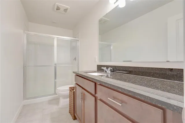 a bedroom with a bed and chair