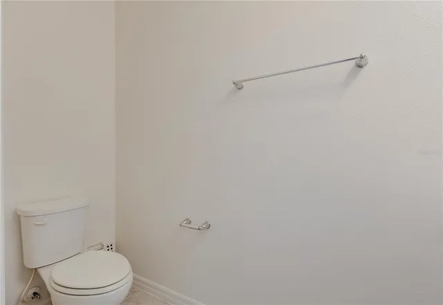 a view of a house with pool and chairs