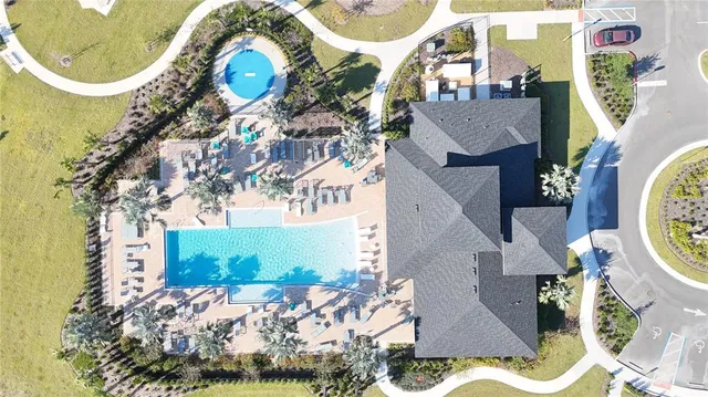 an aerial view of a house with swimming pool and outdoor space