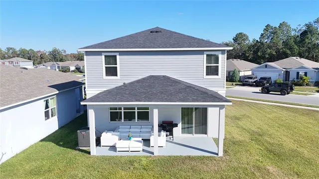 a front view of a house with a yard and lake view