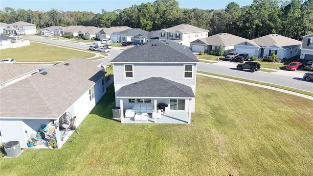 a front view of a house with a yard and lake view