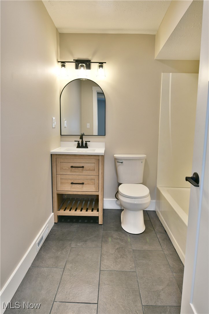 7655 Connelly Road Masury, OH 44438 - Photo 23 of 46 Bathroom with vanity, a bathtub, and tile patterned floors