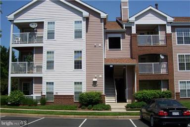 20950 Timber Ridge Terrace, Unit 203 Ashburn, VA 20147 - Photo 2 of 30 a couple of potted plants in front of a building