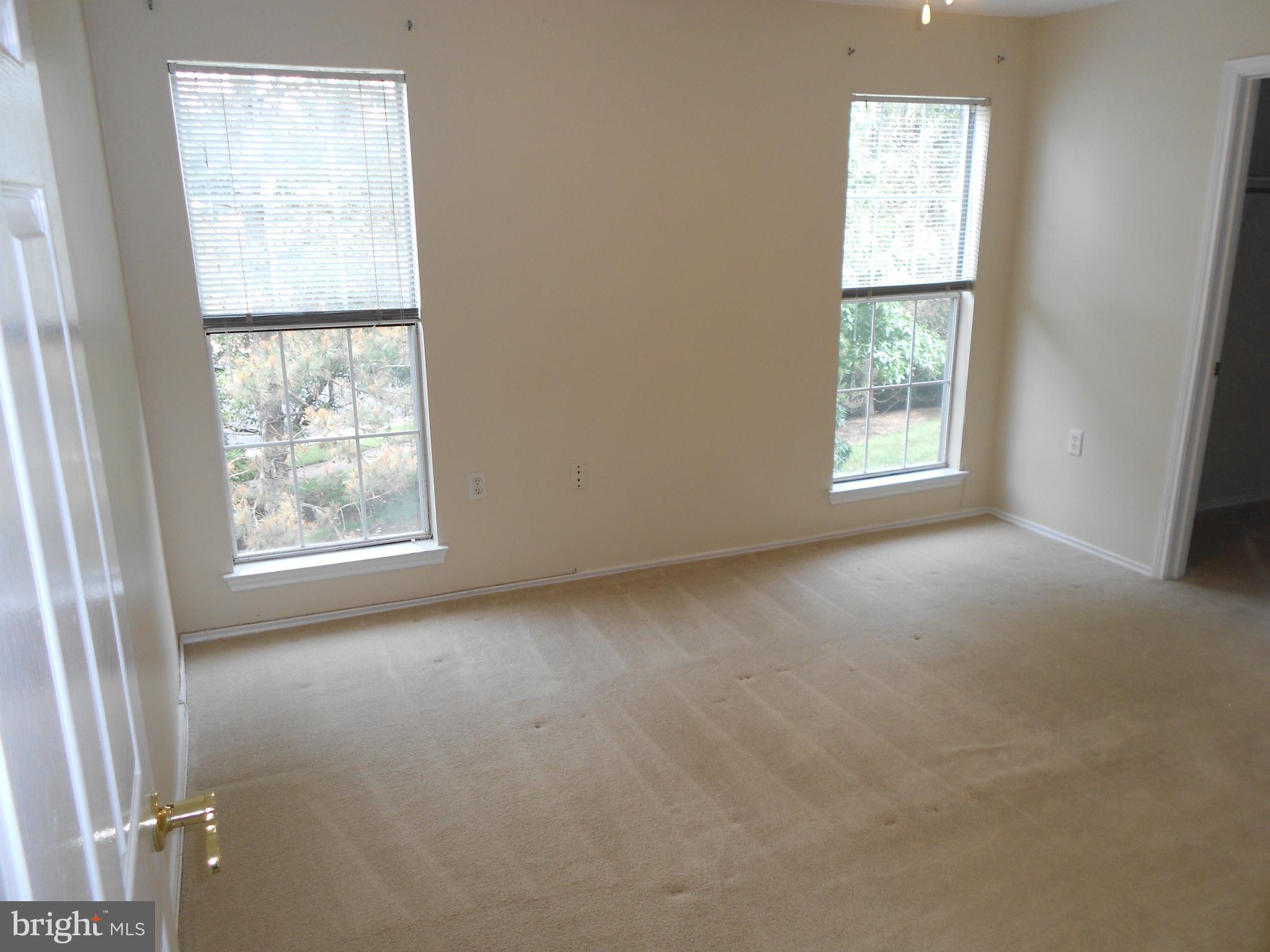 20950 Timber Ridge Terrace, Unit 203 Ashburn, VA 20147 - Photo 12 of 30 an empty room with windows
