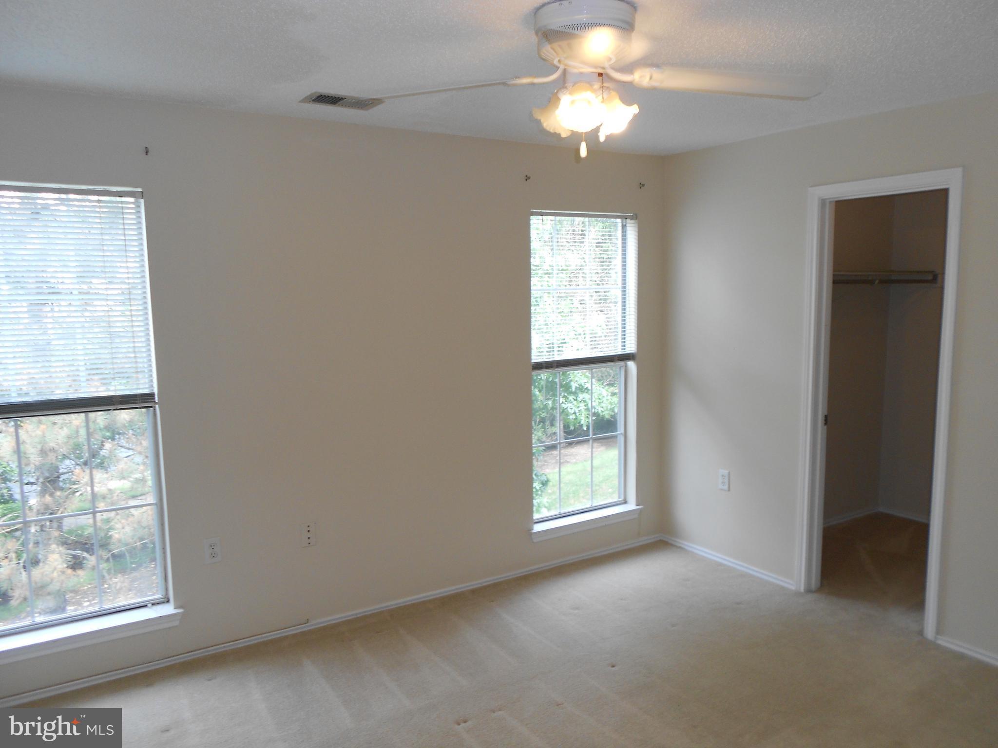 20950 Timber Ridge Terrace, Unit 203 Ashburn, VA 20147 - Photo 14 of 30 an empty room with windows and fan
