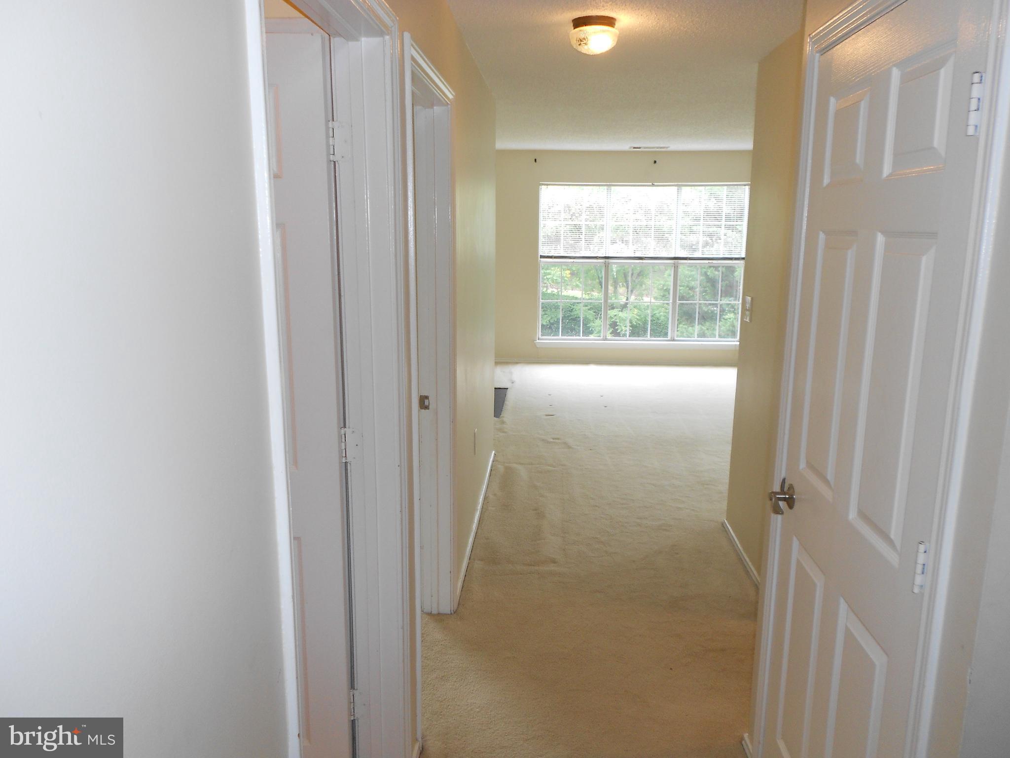 20950 Timber Ridge Terrace, Unit 203 Ashburn, VA 20147 - Photo 3 of 30 a view of an empty room with a window