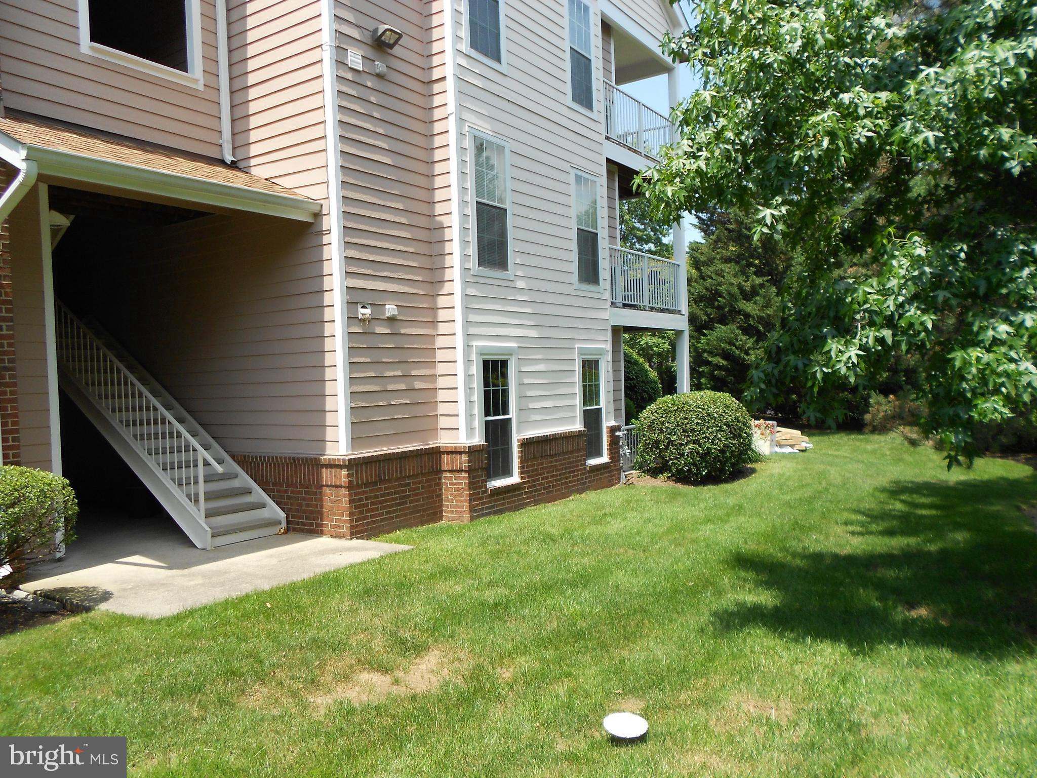 20950 Timber Ridge Terrace, Unit 203 Ashburn, VA 20147 - Photo 23 of 30 a view of a house with a backyard