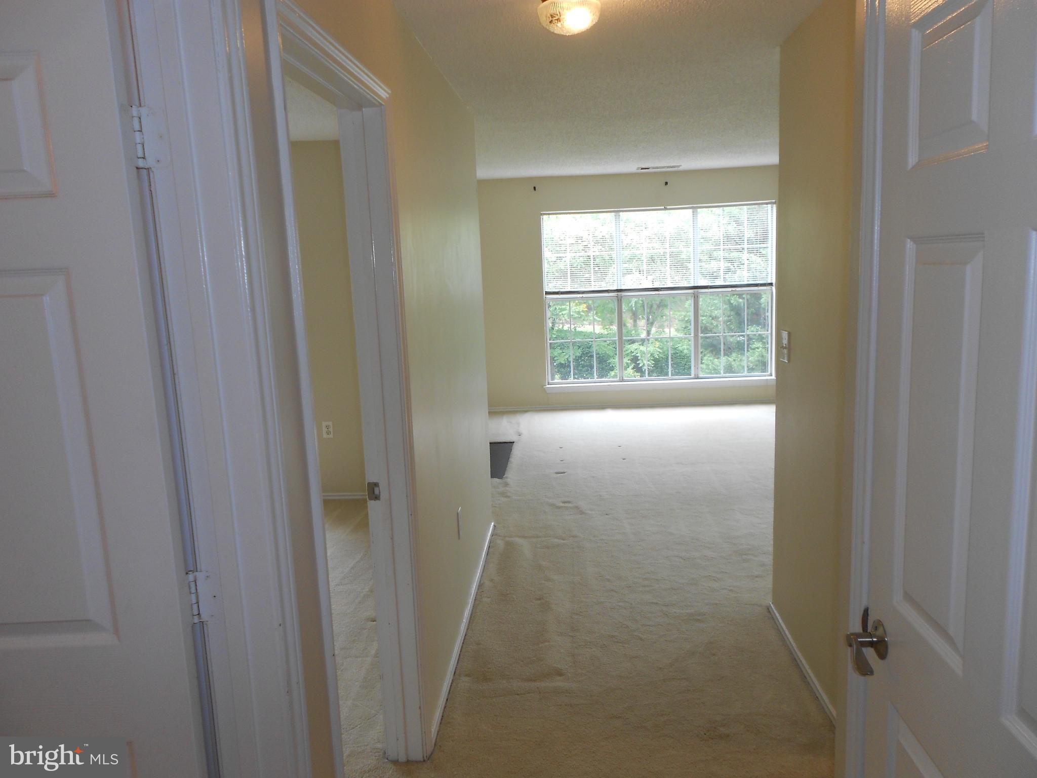 20950 Timber Ridge Terrace, Unit 203 Ashburn, VA 20147 - Photo 4 of 30 a view of an empty room with a window