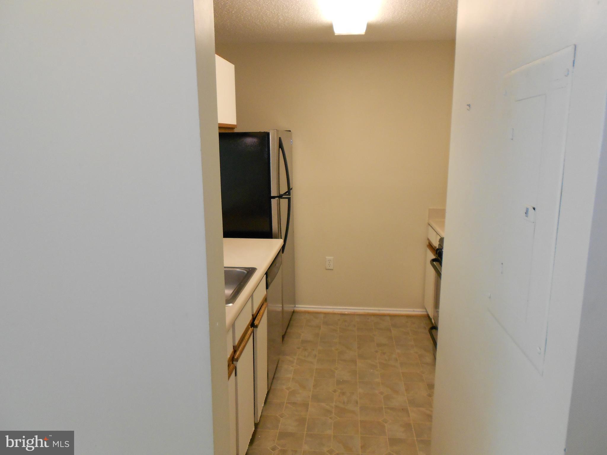20950 Timber Ridge Terrace, Unit 203 Ashburn, VA 20147 - Photo 5 of 30 a view of a hallway with a white walls